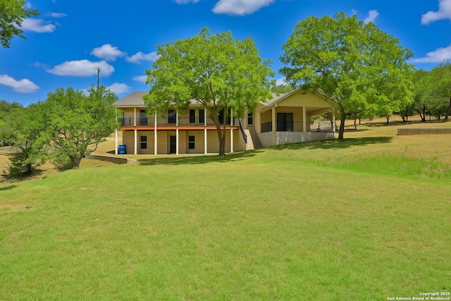 rear view of house with a lawn and a deck