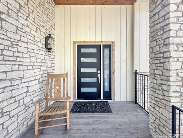 property entrance featuring stone siding