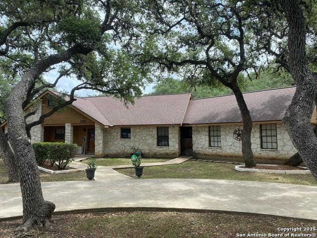 9516 Geronimo Oaks, San Antonio, TX 78254 - view of front of property with stone siding and a shingled roof