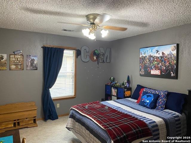 9516 Geronimo Oaks, San Antonio, TX 78254 - bedroom featuring carpet flooring, a textured ceiling, and a ceiling fan