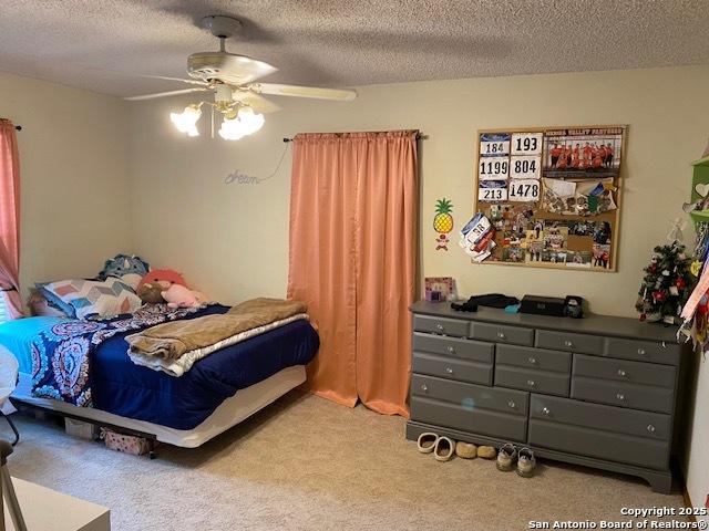 9516 Geronimo Oaks, San Antonio, TX 78254 - bedroom with carpet floors, a textured ceiling, and a ceiling fan