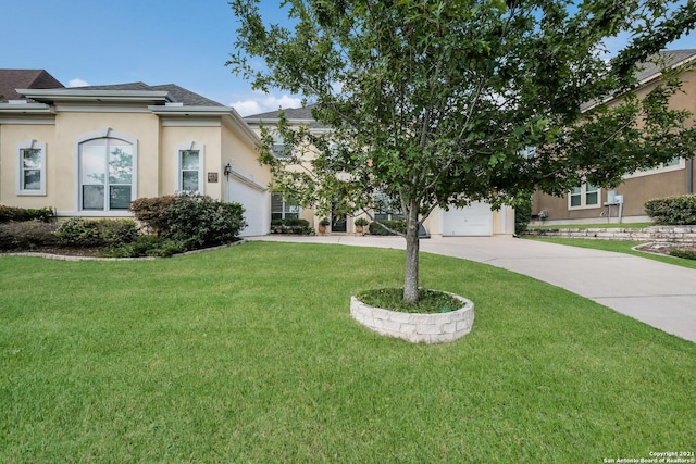 18211 Branson Fls, San Antonio, TX 78255 - view of front of home with driveway, stucco siding, an attached garage, a front yard, and roof with shingles