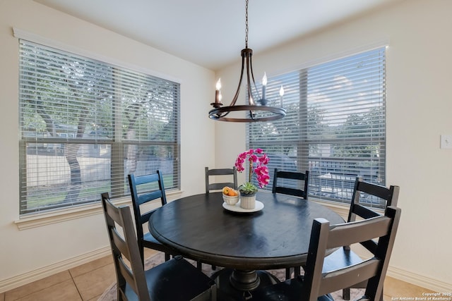 dining area featuring a chandelier, baseboards, and light tile patterned floors
