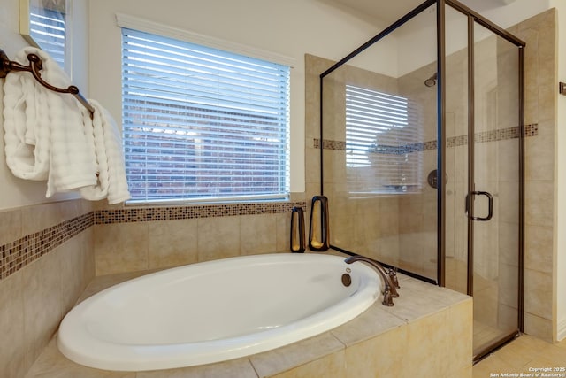 full bathroom with a shower stall and a garden tub