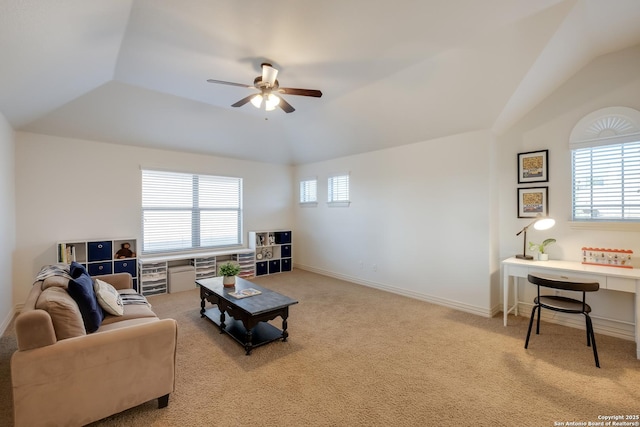 carpeted living room with ceiling fan, lofted ceiling, an office area, and baseboards