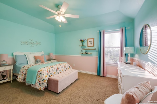 bedroom featuring light colored carpet, lofted ceiling, a ceiling fan, and baseboards