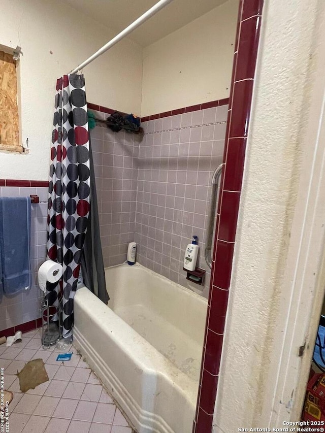 314 Veda Mae, San Antonio, TX 78216 - full bath featuring tile patterned floors, shower / bath combo, a textured wall, and a wainscoted wall
