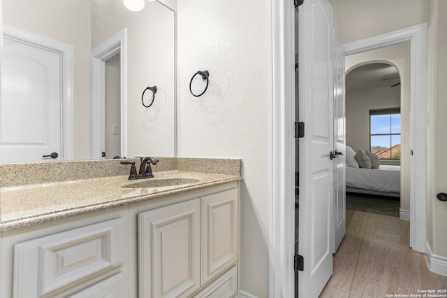 ensuite bathroom with vanity and baseboards