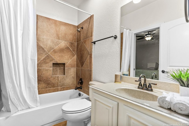 bathroom with a textured wall, shower / tub combo, toilet, vanity, and ceiling fan