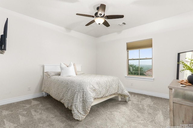 carpeted bedroom with baseboards and a ceiling fan