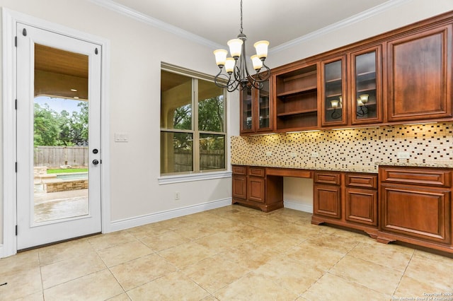 unfurnished office featuring healthy amount of natural light, ornamental molding, a chandelier, built in study area, and light tile patterned floors