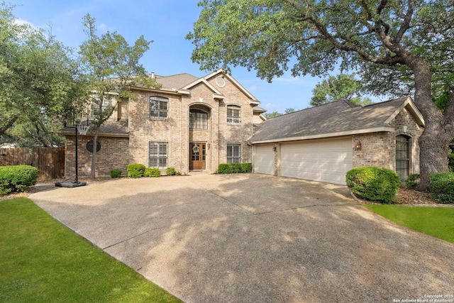 16222 Deer Crst, San Antonio, TX 78248 - view of front of house with concrete driveway, an attached garage, brick siding, and a shingled roof