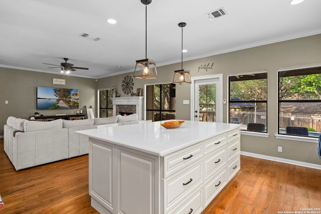 16222 Deer Crst, San Antonio, TX 78248 - kitchen with plenty of natural light, light wood-type flooring, a fireplace, light countertops, and recessed lighting