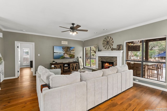 16222 Deer Crst, San Antonio, TX 78248 - living area with wood-type flooring, a ceiling fan, crown molding, a brick fireplace, and baseboards