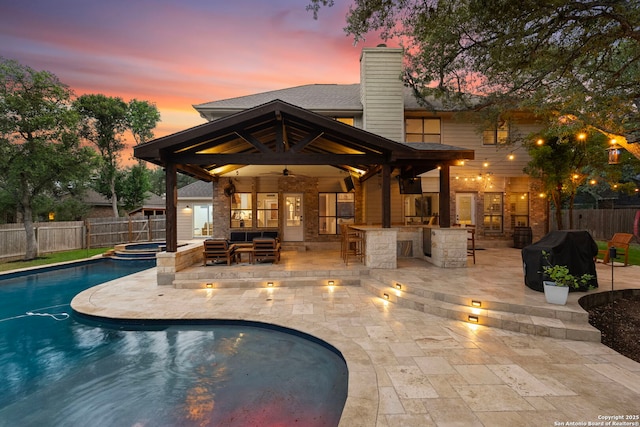 16222 Deer Crst, San Antonio, TX 78248 - pool at dusk featuring a fenced backyard, ceiling fan, a patio, and a pool with connected hot tub