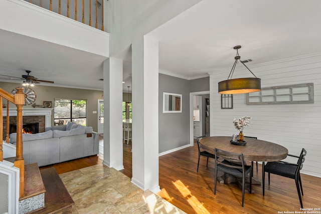 16222 Deer Crst, San Antonio, TX 78248 - dining room with ceiling fan, a fireplace, crown molding, baseboards, and wood finished floors