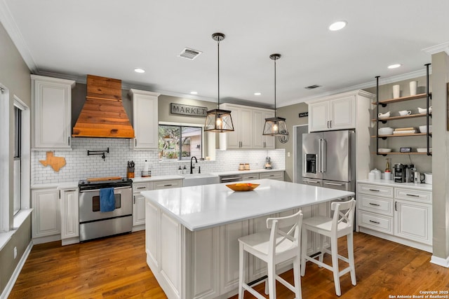 16222 Deer Crst, San Antonio, TX 78248 - kitchen featuring appliances with stainless steel finishes, premium range hood, a sink, decorative backsplash, and a kitchen island