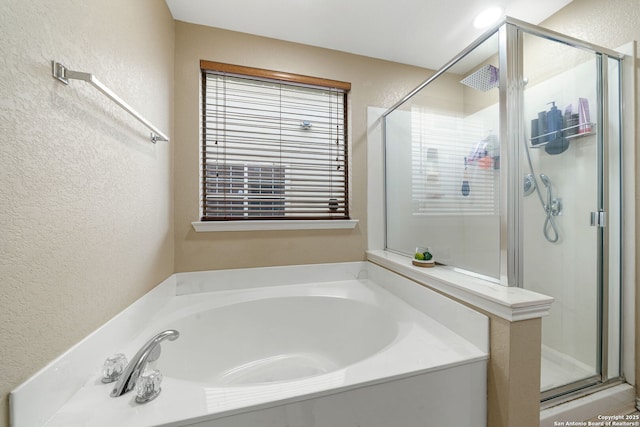13303 Sunset Rainbow, San Antonio, TX 78245 - full bathroom with a textured wall, a shower stall, a garden tub, and healthy amount of natural light