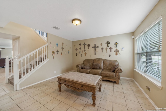 13303 Sunset Rainbow, San Antonio, TX 78245 - living room featuring stairs, light tile patterned floors, and baseboards