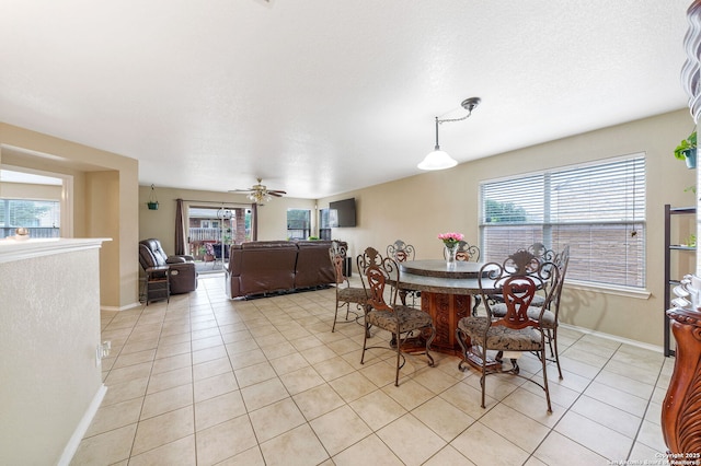 13303 Sunset Rainbow, San Antonio, TX 78245 - dining area featuring light tile patterned floors, healthy amount of natural light, baseboards, and a ceiling fan