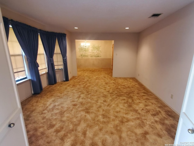 carpeted spare room with recessed lighting, a chandelier, and baseboards