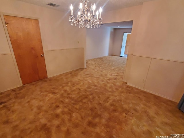 unfurnished dining area featuring a chandelier and carpet floors