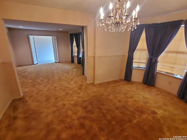 unfurnished dining area with a chandelier and carpet flooring