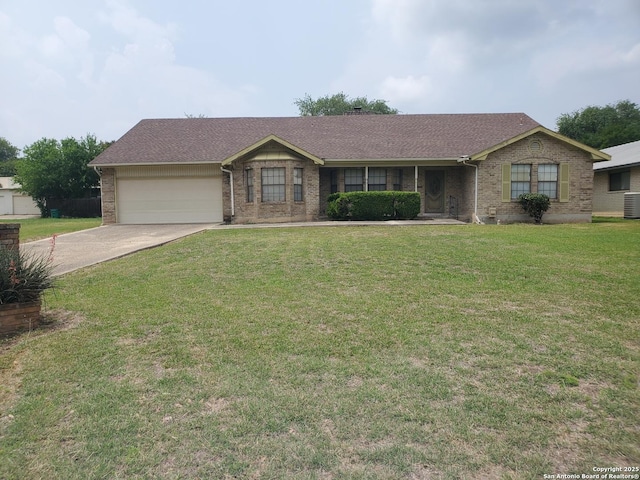 single story home with an attached garage, concrete driveway, brick siding, a front yard, and central AC unit