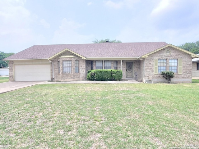 ranch-style house featuring a garage, brick siding, driveway, a front lawn, and roof with shingles