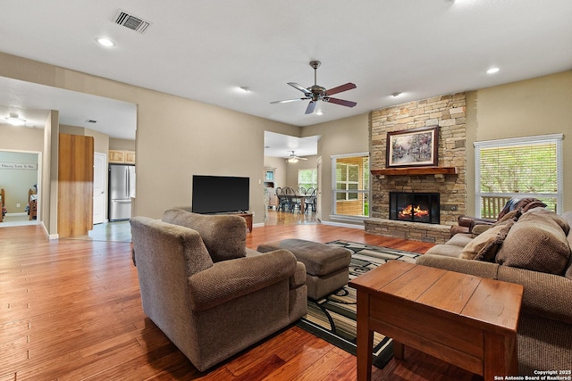 1200 Brand, Bulverde, TX 78163 - living room with a ceiling fan, healthy amount of natural light, light wood-style floors, recessed lighting, and a stone fireplace
