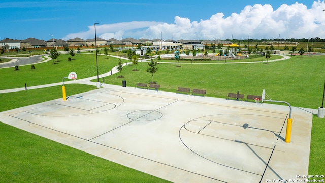 surrounding community with community basketball court, a yard, and a residential view