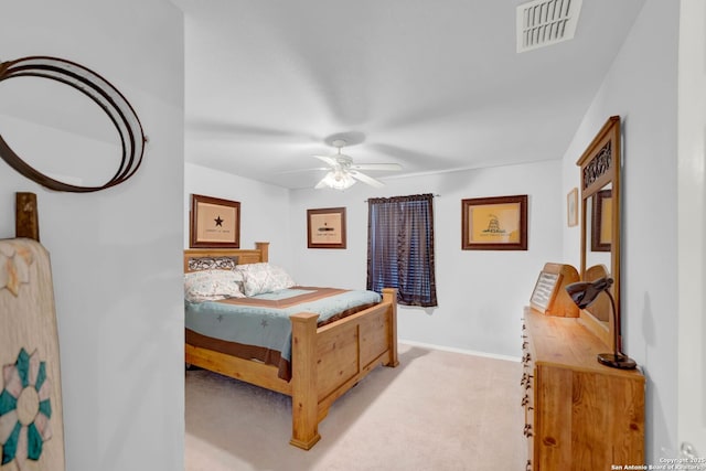 bedroom featuring light colored carpet, a ceiling fan, and baseboards