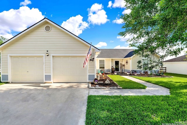 ranch-style home featuring concrete driveway, a front yard, and an attached garage