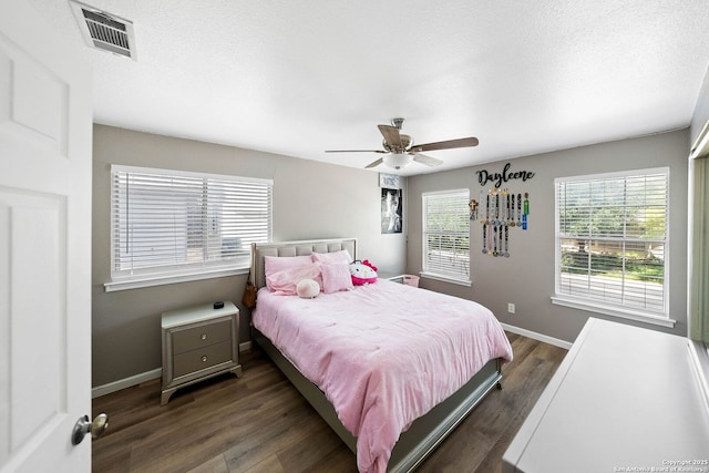 bedroom with wood finished floors, baseboards, and a ceiling fan