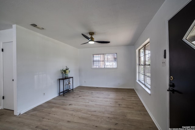 2114 S Trinity St, San Antonio, TX 78207 - empty room with a ceiling fan, wood finished floors, and baseboards