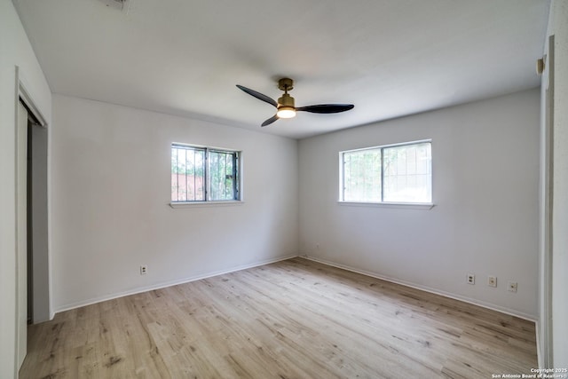 2114 S Trinity St, San Antonio, TX 78207 - unfurnished bedroom featuring light wood finished floors, baseboards, a closet, and a ceiling fan