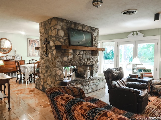 6719 State Highway 55, Uvalde, TX 78801 - living room featuring light tile patterned floors and a fireplace
