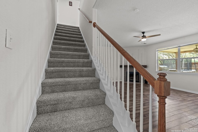 25836 Stone Cyn, San Antonio, TX 78260 - staircase with ceiling fan, wood finished floors, and a textured ceiling