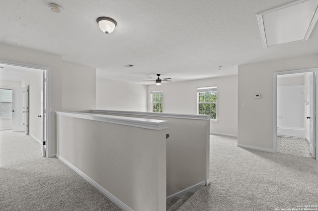 25836 Stone Cyn, San Antonio, TX 78260 - hall with attic access, carpet floors, an upstairs landing, and a textured ceiling
