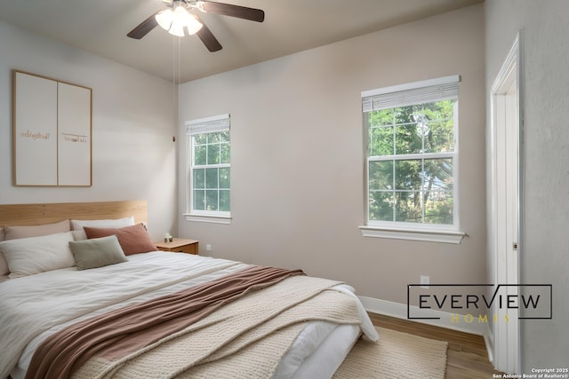 3039 View Rdg Unit 3, Spring Branch, TX 78070 - bedroom featuring wood finished floors, baseboards, and a ceiling fan