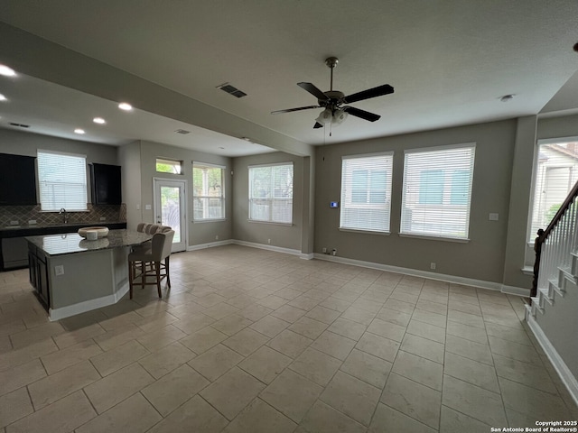 17339 Brachetto, San Antonio, TX 78247 - living area with a ceiling fan, baseboards, light tile patterned floors, stairs, and recessed lighting