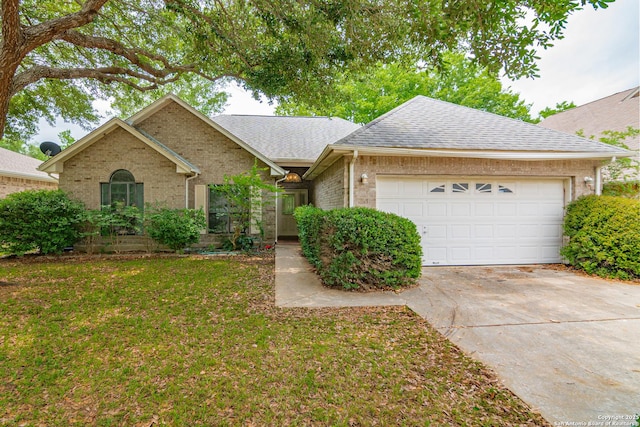 view of front facade with concrete driveway, an attached garage, brick siding, roof with shingles, and a front lawn