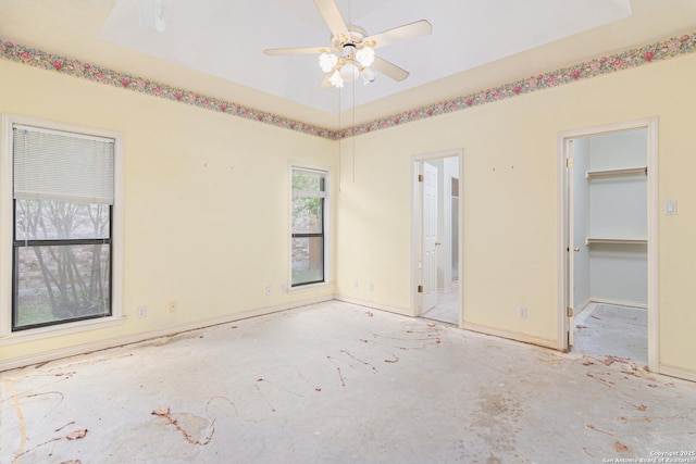unfurnished bedroom with a spacious closet and ensuite bath