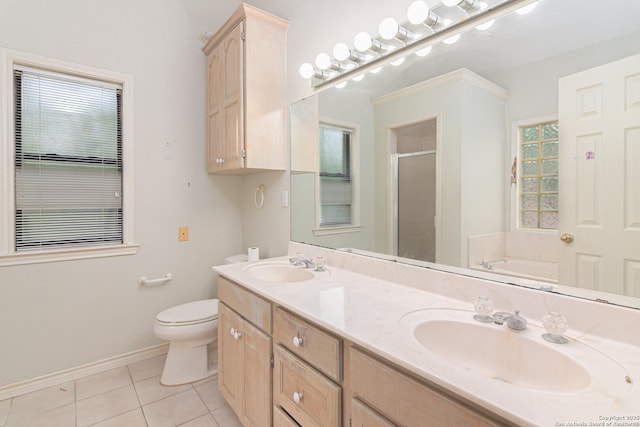 bathroom featuring a shower stall, tile patterned floors, toilet, double vanity, and baseboards