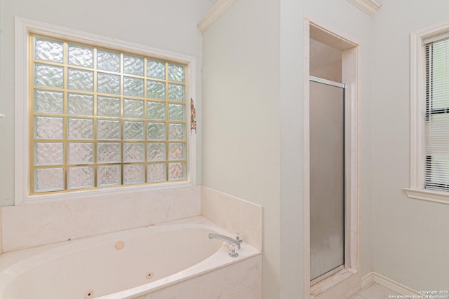 full bath featuring a shower stall and a tub with jets
