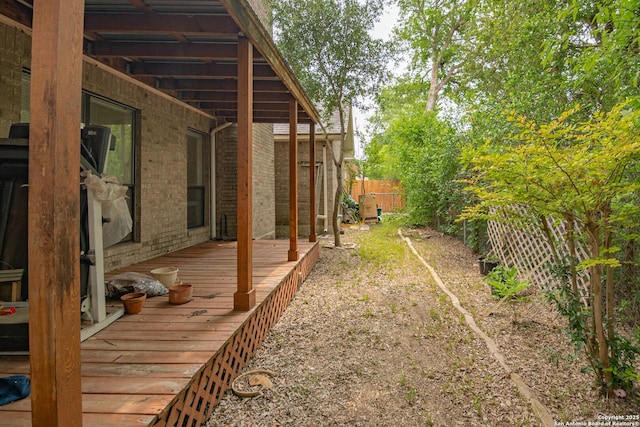 view of yard featuring a deck and fence