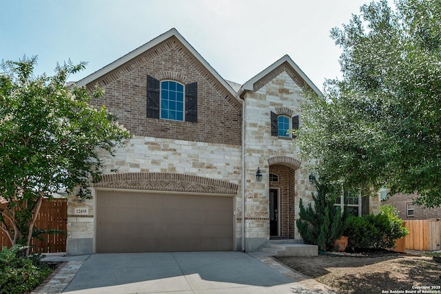 12418 Maverick Rnch, San Antonio, TX 78254 - french country home with stone siding, concrete driveway, fence, and an attached garage