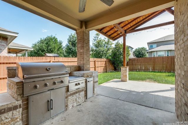 12418 Maverick Rnch, San Antonio, TX 78254 - view of patio / terrace featuring grilling area, a fenced backyard, exterior kitchen, and a ceiling fan