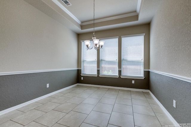 12418 Maverick Rnch, San Antonio, TX 78254 - empty room with a textured wall, crown molding, a chandelier, light tile patterned floors, and a raised ceiling