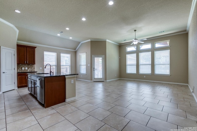 12418 Maverick Rnch, San Antonio, TX 78254 - kitchen with dark countertops, a ceiling fan, crown molding, open floor plan, and a sink
